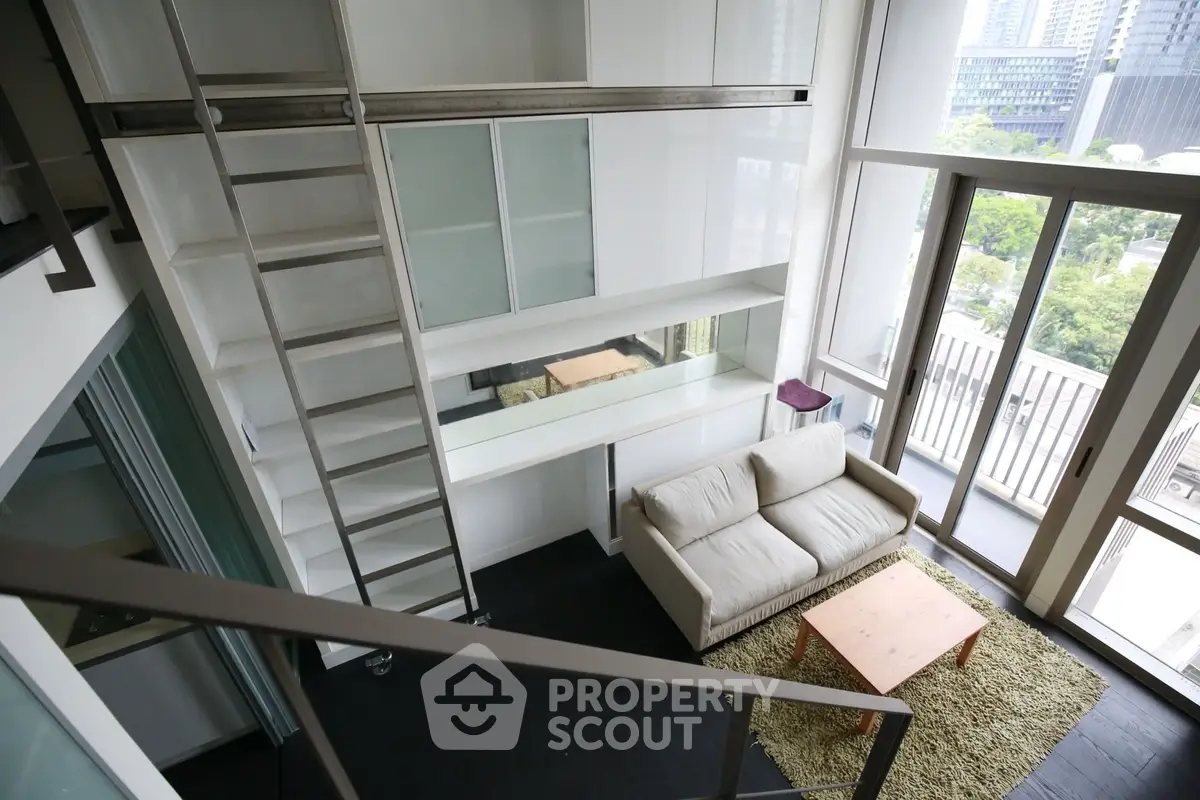 Modern loft-style living room with large windows and balcony view