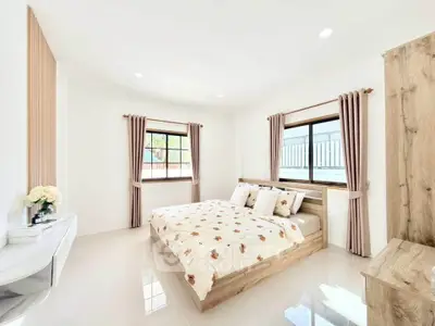 Bright and airy bedroom with modern decor and large windows in a stylish home.