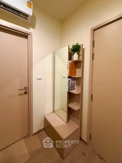 Modern entryway with sleek storage and mirror, perfect for compact living spaces.