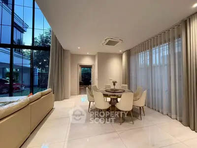 Luxurious modern living room with elegant dining area and large windows