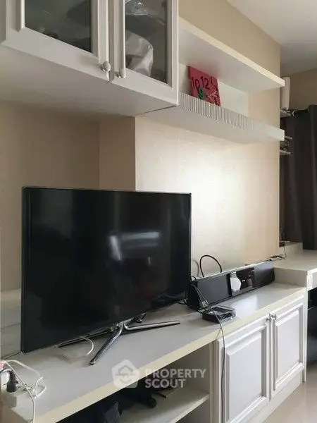 Modern living room with sleek TV setup and stylish shelving