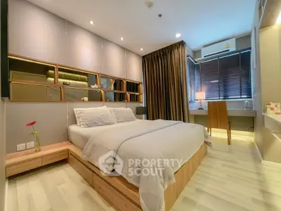 Modern bedroom with stylish decor and natural light, featuring a cozy bed and elegant furnishings.