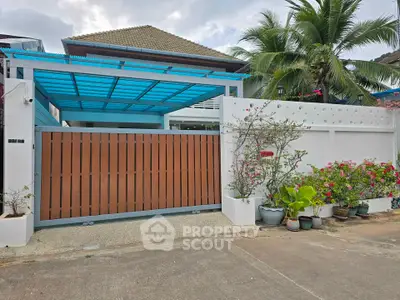 Charming suburban house with modern gate and lush garden, perfect for family living.