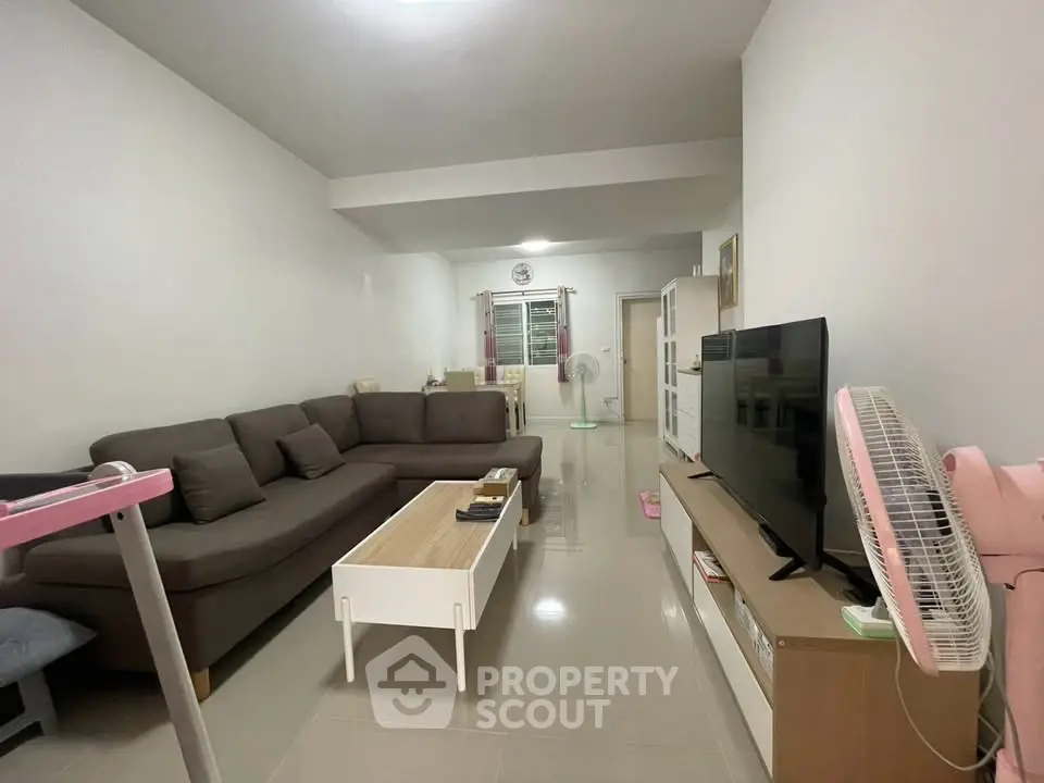 Spacious living room with modern furniture and sleek design, perfect for family gatherings.