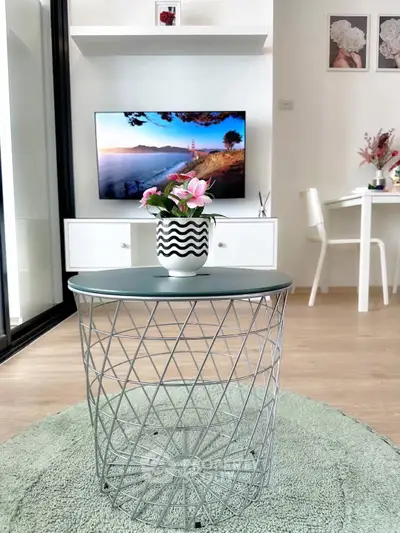 Modern living room with stylish decor and TV, featuring a chic coffee table and elegant flooring.