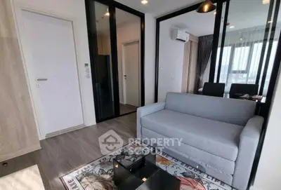 Modern living room with sleek design and large windows offering natural light.