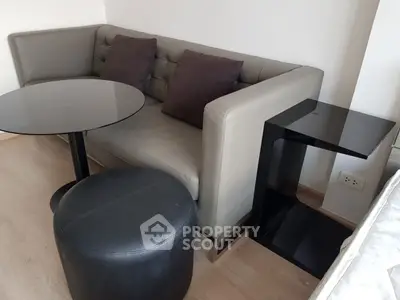 Modern living room with stylish corner sofa and sleek black tables