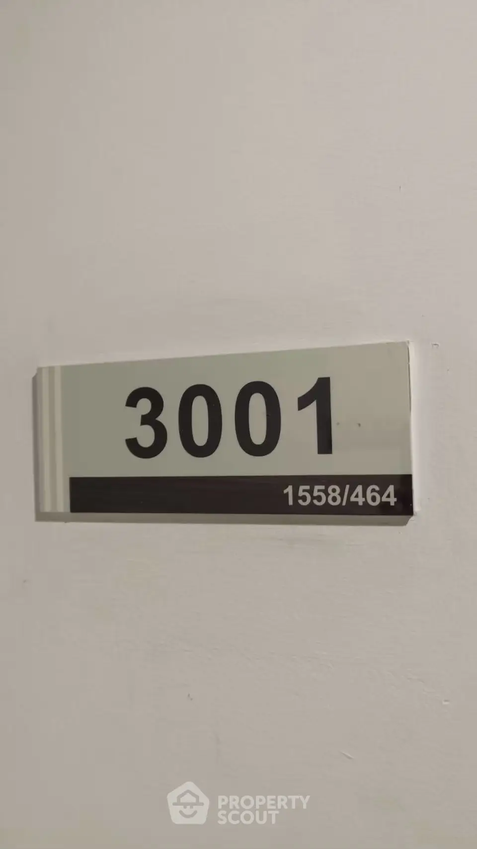 Apartment door number 3001 on a white wall, indicating a modern residential unit.