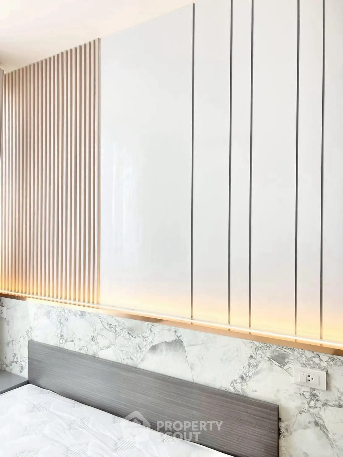 Modern bedroom with sleek paneling and ambient lighting