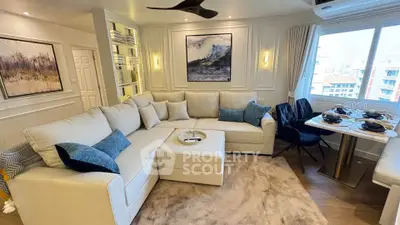 Luxurious living room with elegant decor and large windows offering city views.
