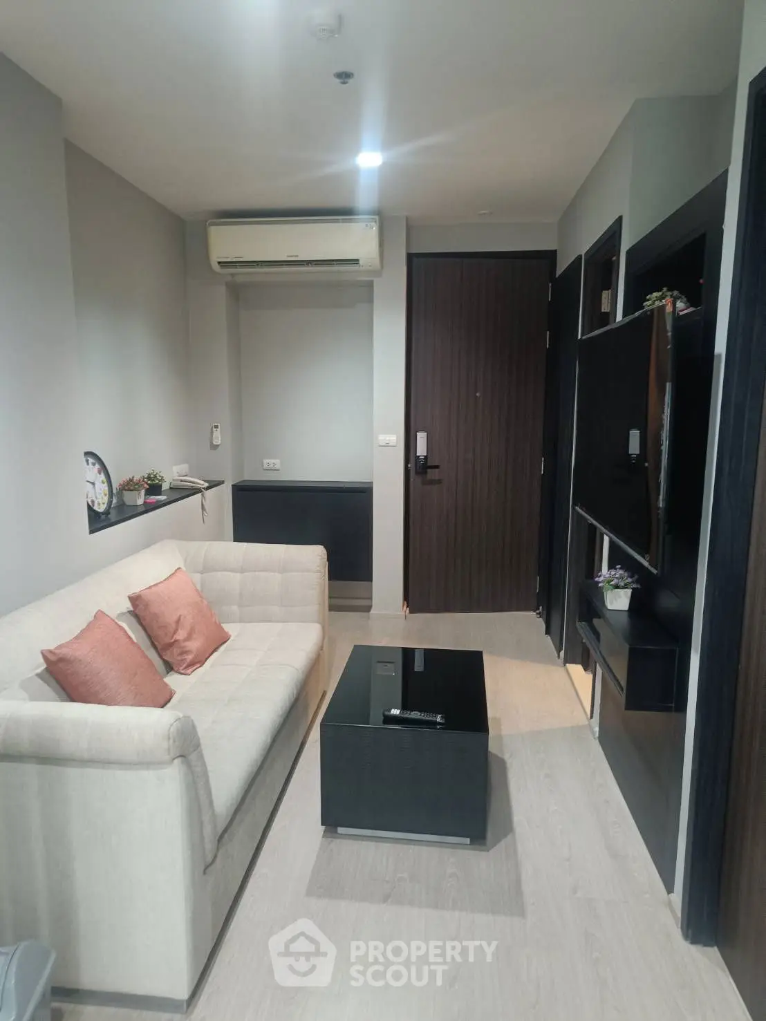 Modern living room with cozy sofa and sleek decor, perfect for urban living.