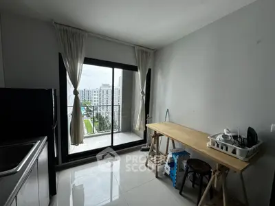 Modern kitchen with balcony view in a high-rise apartment