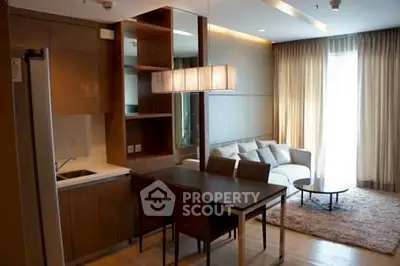 Modern living room with open kitchen and stylish dining area