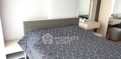 Modern bedroom with stylish geometric bedding and sleek wooden furniture.