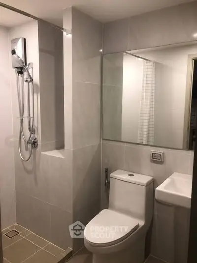 Modern bathroom with sleek fixtures and a spacious shower area in a contemporary apartment.