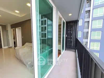 Modern apartment with spacious balcony and sliding glass doors, offering urban living at its finest.