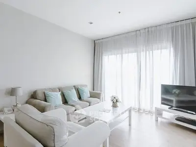 Bright and airy living room with modern decor and large windows.