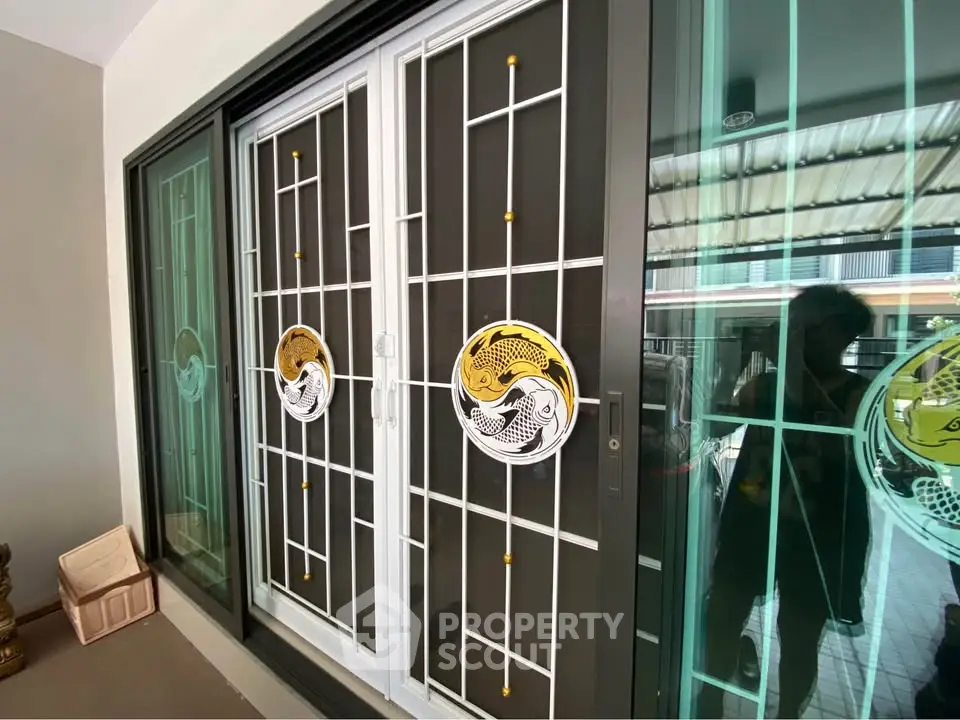 Stylish sliding glass doors with decorative metal grill in modern home exterior.
