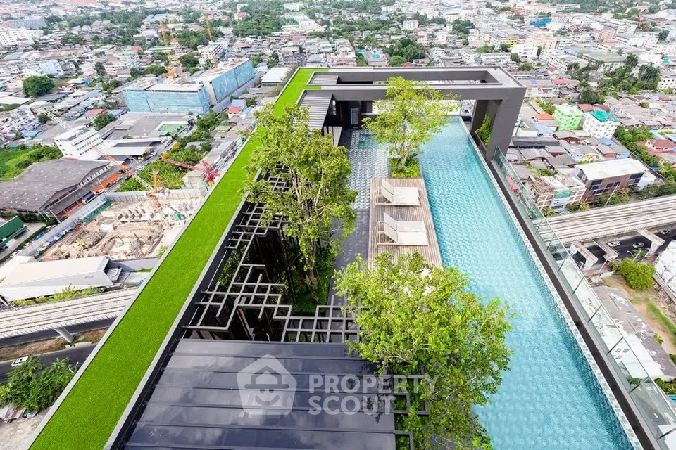 Stunning rooftop pool with lush greenery and panoramic city views, perfect for luxury urban living.