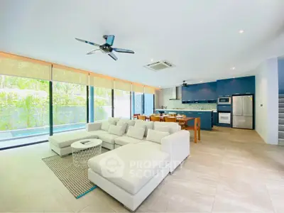 Spacious modern living room with open kitchen and large windows