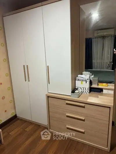 Modern bedroom with stylish wardrobe and dresser, featuring sleek design and ample storage space.