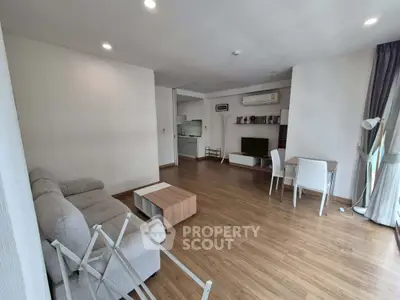 Spacious living room with modern decor and wooden flooring