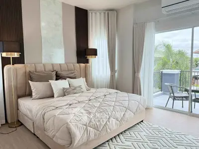 Luxurious bedroom with elegant decor and balcony view, perfect for relaxation and comfort.