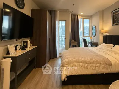 Modern bedroom with city view, stylish decor, and cozy ambiance in urban apartment.