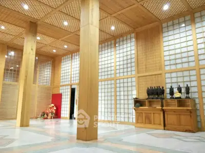 Elegant interior with wooden lattice walls and ceiling, showcasing a serene and spacious ambiance.