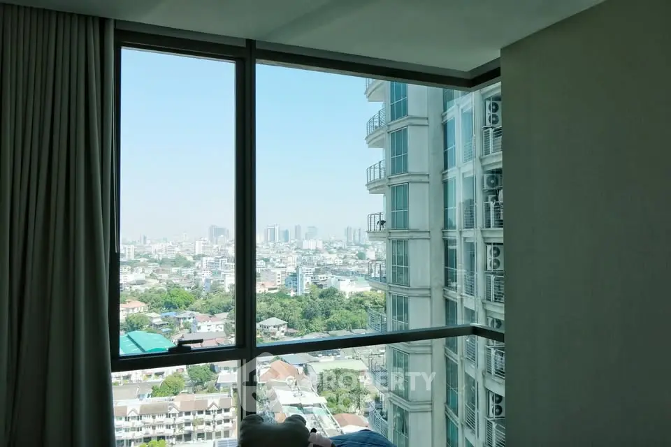 Stunning cityscape view from a modern high-rise apartment window, showcasing urban living at its finest.