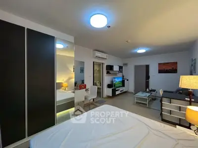 Modern studio apartment with sleek furniture and ambient lighting, featuring a cozy living area and stylish decor.