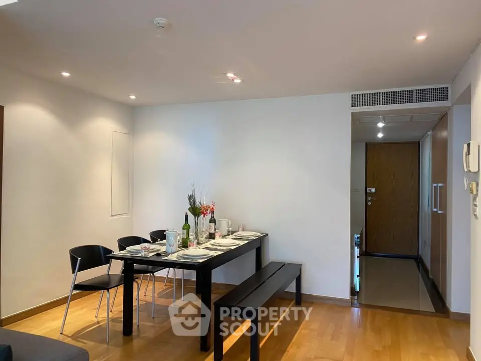 Modern dining area with sleek table and chairs in a stylish apartment interior.