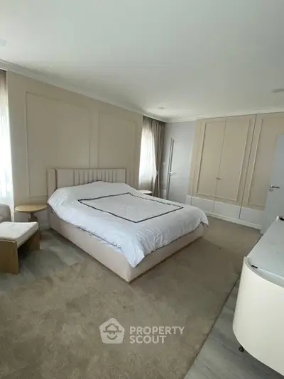 Spacious modern bedroom with elegant decor and large bed