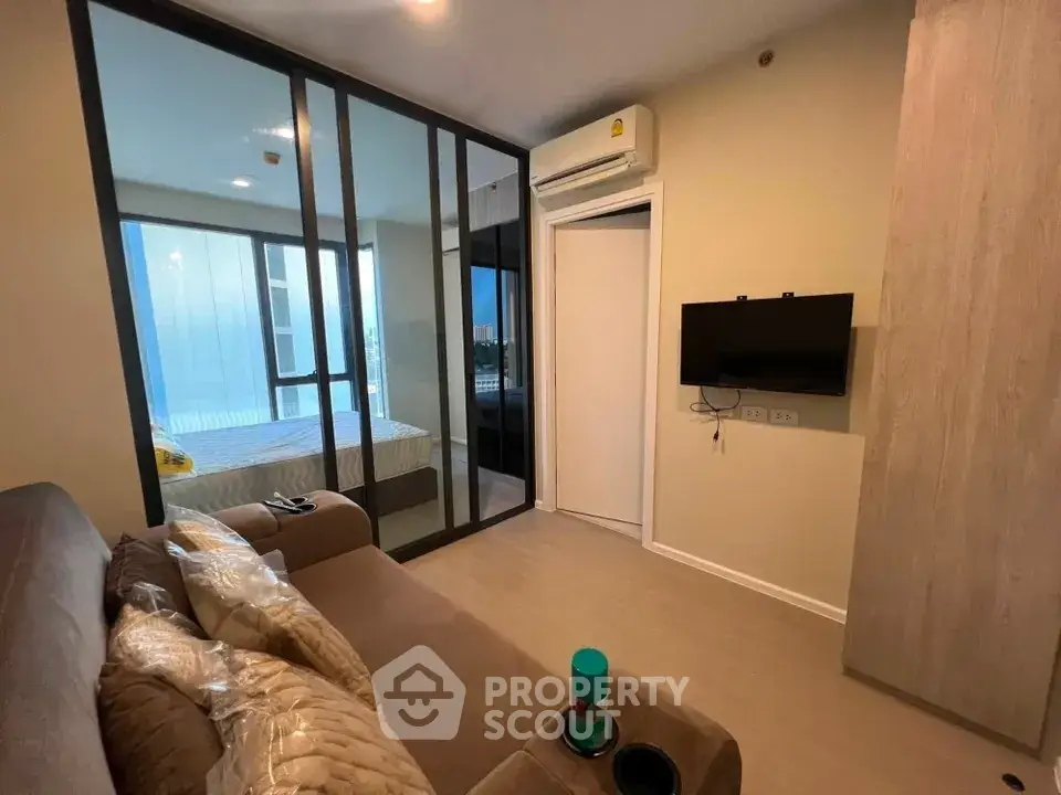 Modern living room with glass partition and cozy decor