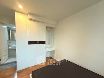 Modern bedroom with ensuite bathroom and sleek wardrobe design