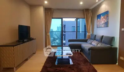 Modern living room with city view, stylish furniture, and elegant decor.