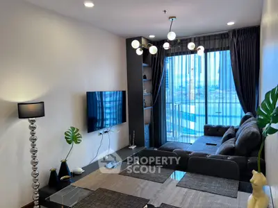 Modern living room with stylish decor and city view from large windows.