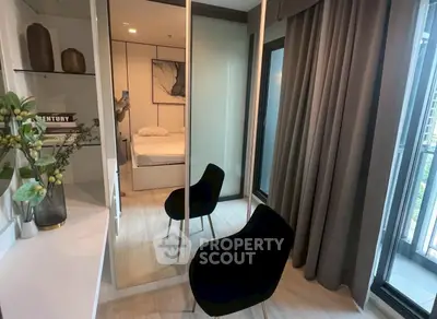 Modern bedroom with mirrored closet and balcony access