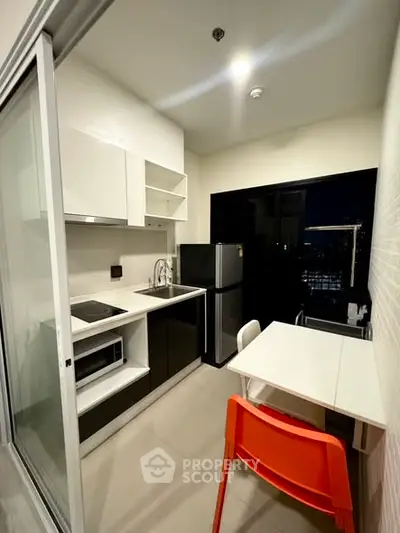 Modern compact kitchen with sleek design and city view