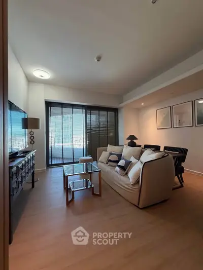 Modern living room with stylish decor and large windows offering natural light.