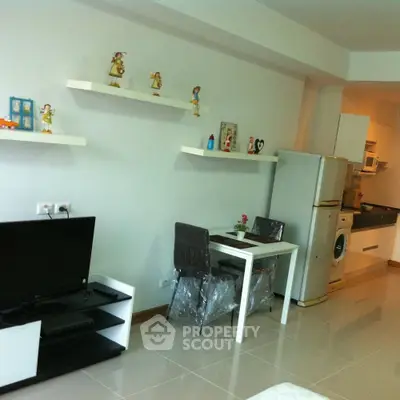 Modern apartment interior with stylish decor, featuring a compact kitchen and cozy dining area.