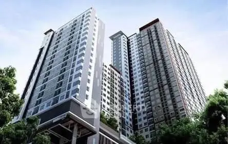 Modern high-rise residential building with sleek design and large windows, surrounded by greenery.
