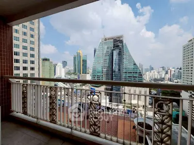 Stunning cityscape view from a spacious balcony in a high-rise building.
