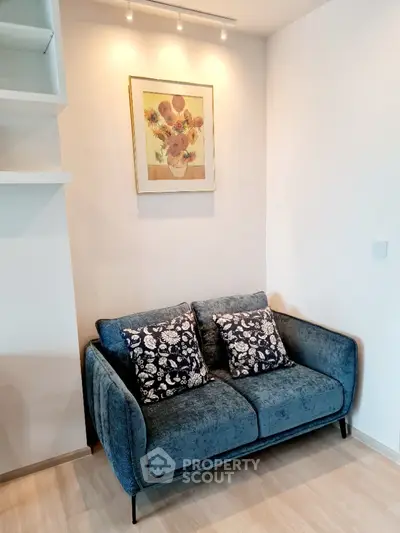 Cozy living room corner with stylish blue sofa and elegant wall art