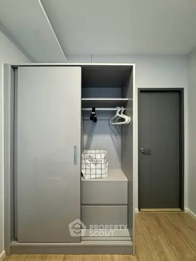 Modern minimalist wardrobe with sliding doors in a stylish bedroom setting.