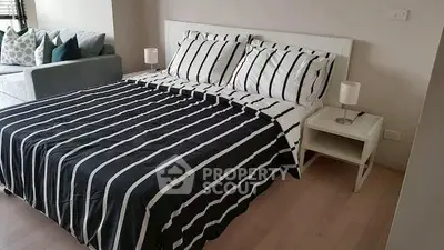 Modern bedroom with stylish striped bedding and cozy ambiance