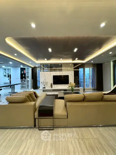 Luxurious modern living room with elegant lighting and spacious seating area.