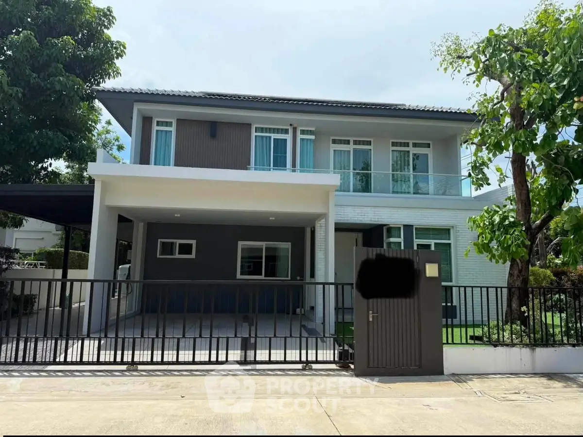 Modern two-story house with sleek design and spacious driveway in a serene neighborhood.