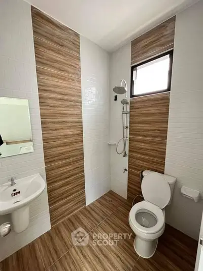 Modern bathroom with wood accent tiles and sleek fixtures
