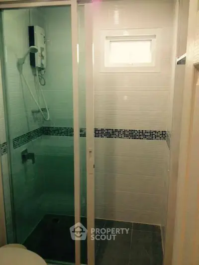 Compact bathroom with modern shower and sliding glass door
